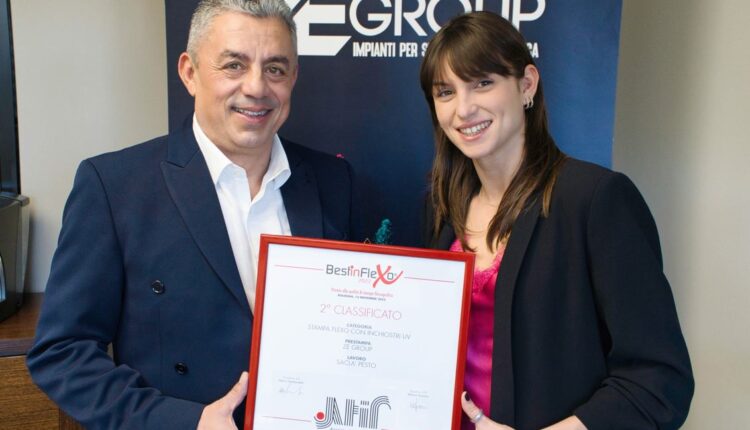 Owner, Sandro Bisoli next to co-owner Noemi Bisoli showing off the ATIF print award.